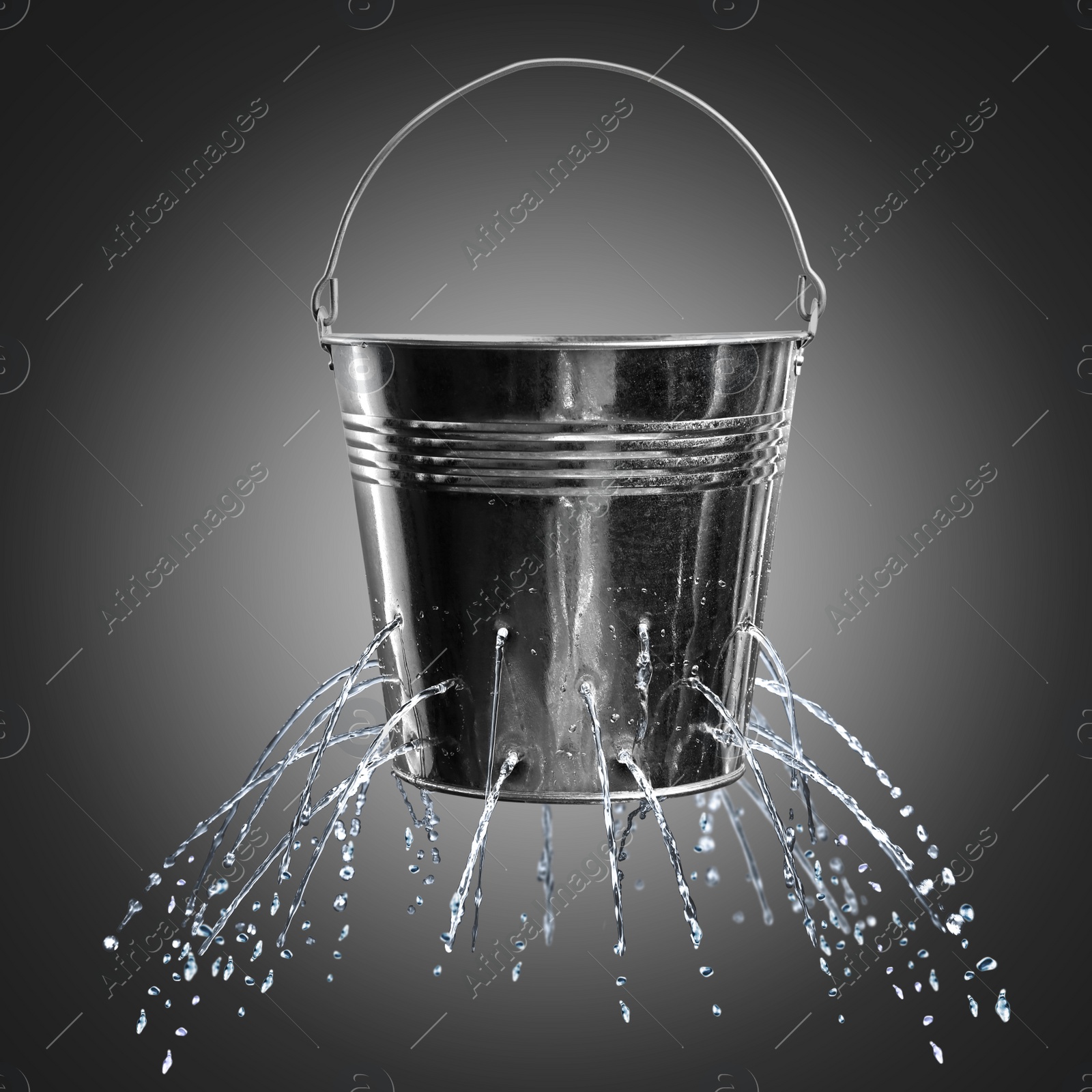 Image of Leaky bucket with water on dark background 