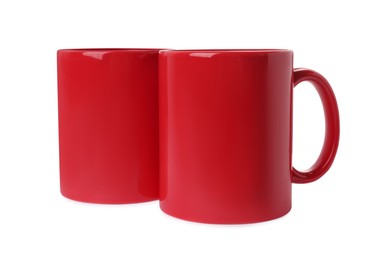 Photo of Two red ceramic mugs isolated on white