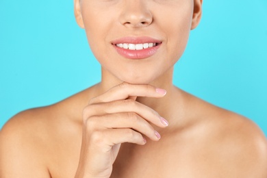 Photo of Closeup view of beautiful young woman on color background. Lips contouring, skin care and cosmetic surgery concept