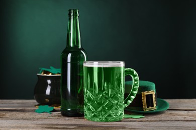 Photo of St. Patrick's day party. Green beer, leprechaun hat, pot of gold and decorative clover leaves on wooden table