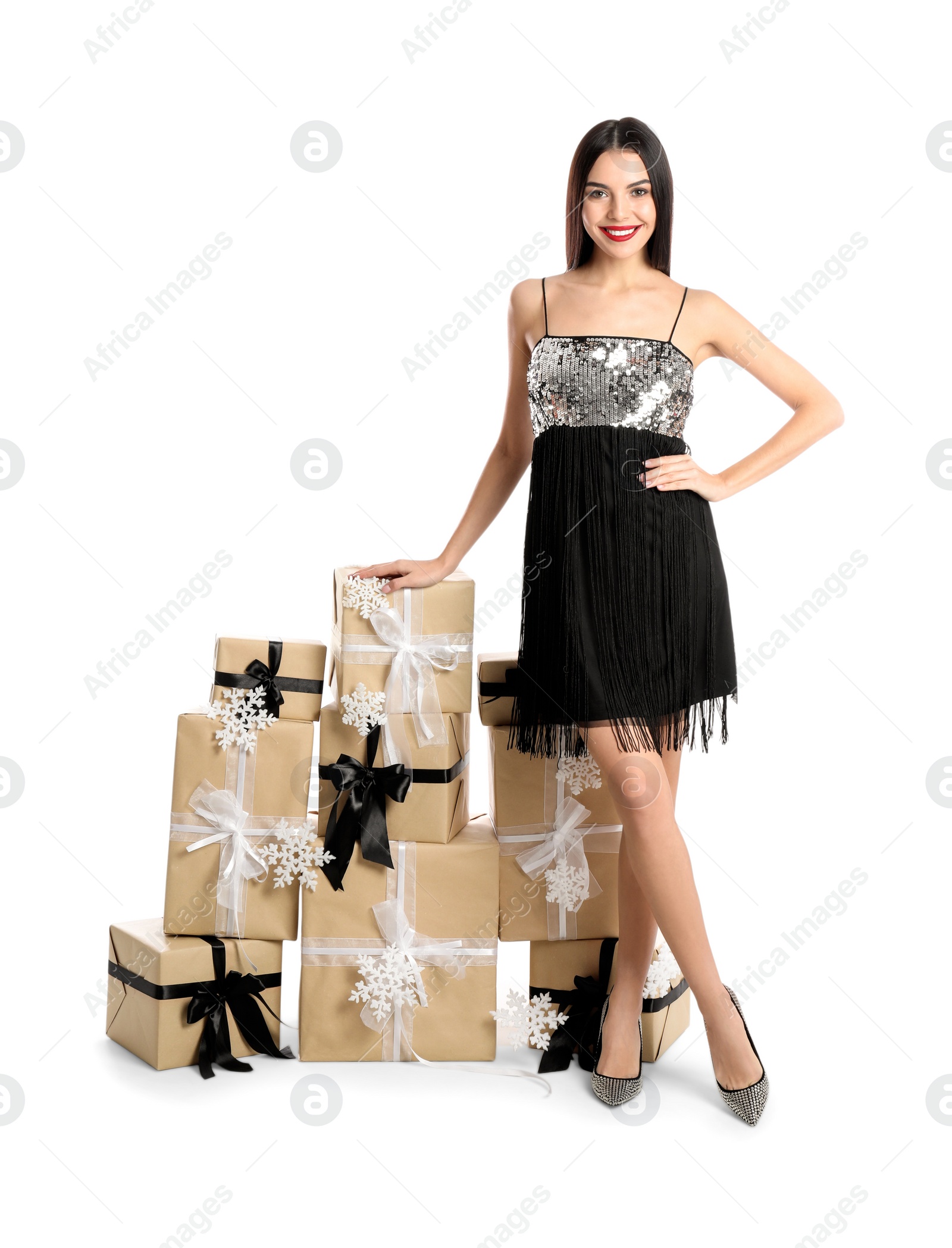 Photo of Woman in party dress with Christmas gifts on white background