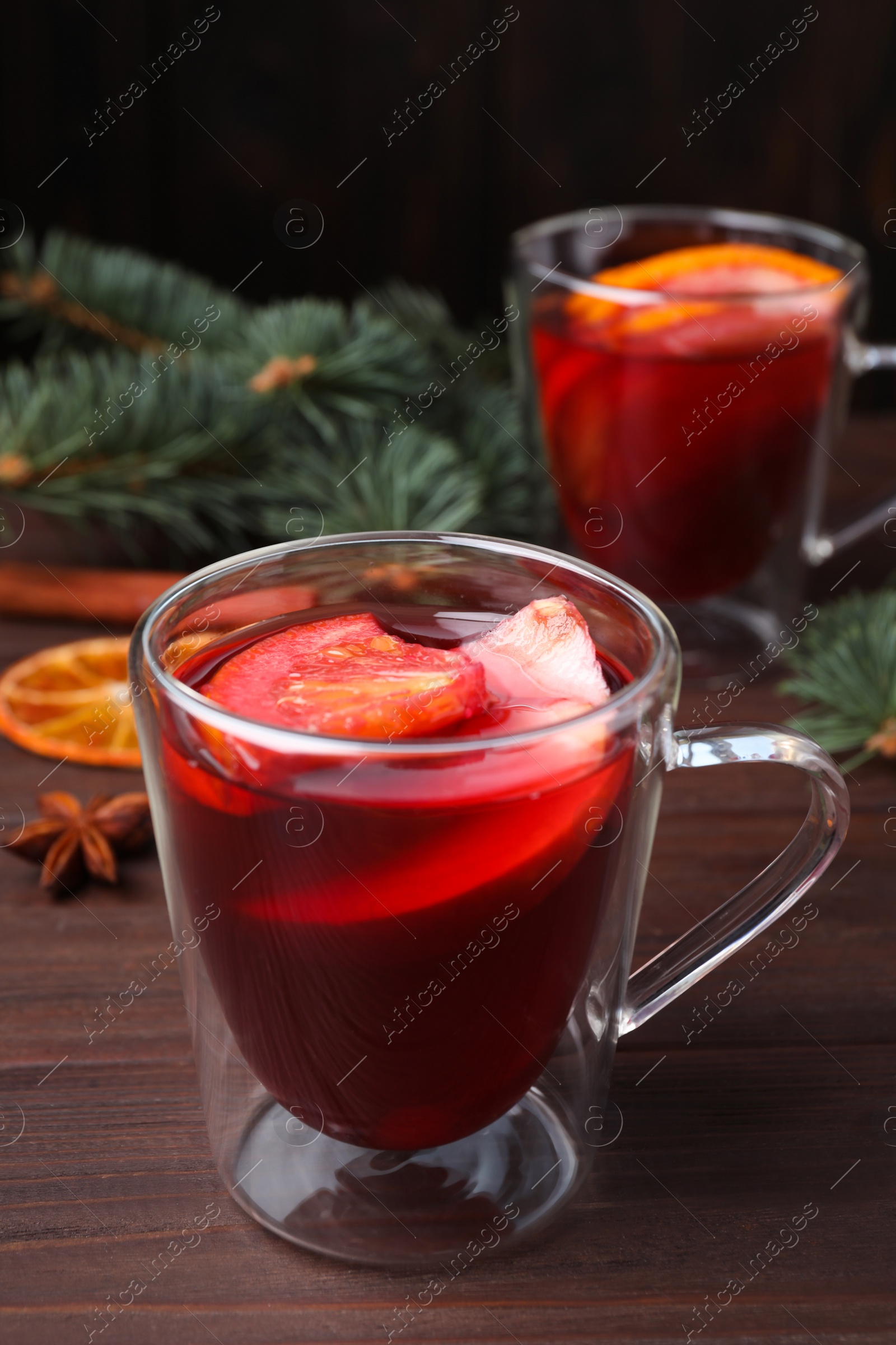 Photo of Delicious hot mulled wine on wooden table