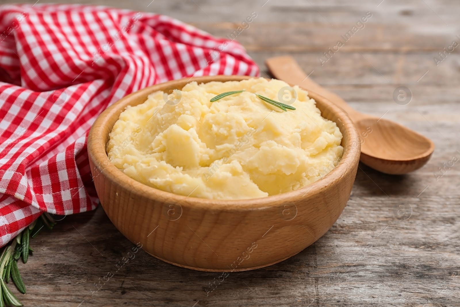 Photo of Bowl with tasty mashed potato on wooden table