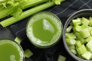 Glass of delicious celery juice and vegetables on table, flat lay