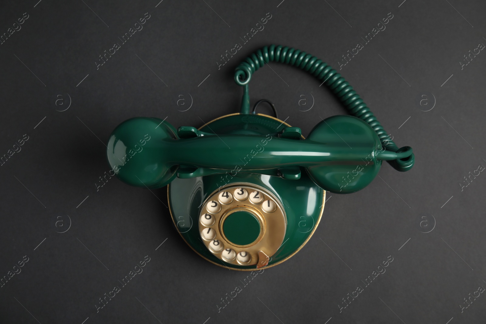 Photo of Elegant vintage green telephone on black background, top view