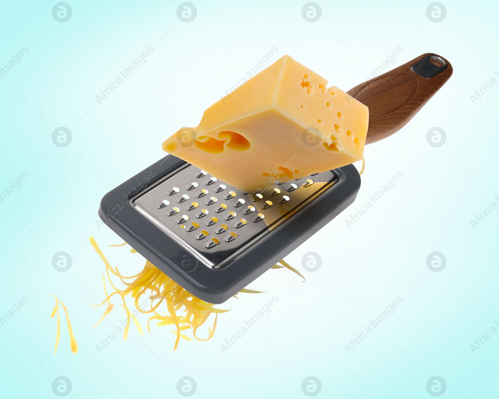 Image of Grating cheese with hand grater on turquoise background