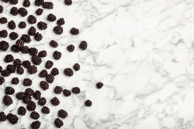 Photo of Flat lay composition with fresh blackberry and space for text on marble background