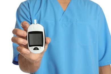 Male doctor holding glucose meter on white background, closeup. Medical object