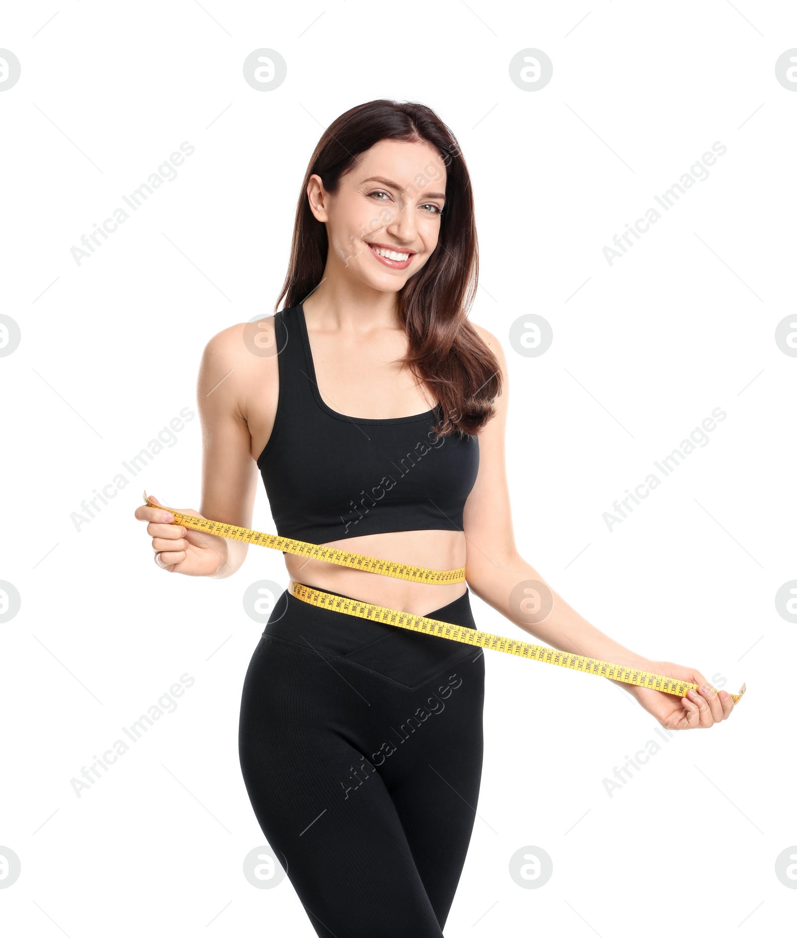 Photo of Happy young woman with measuring tape showing her slim body against white background