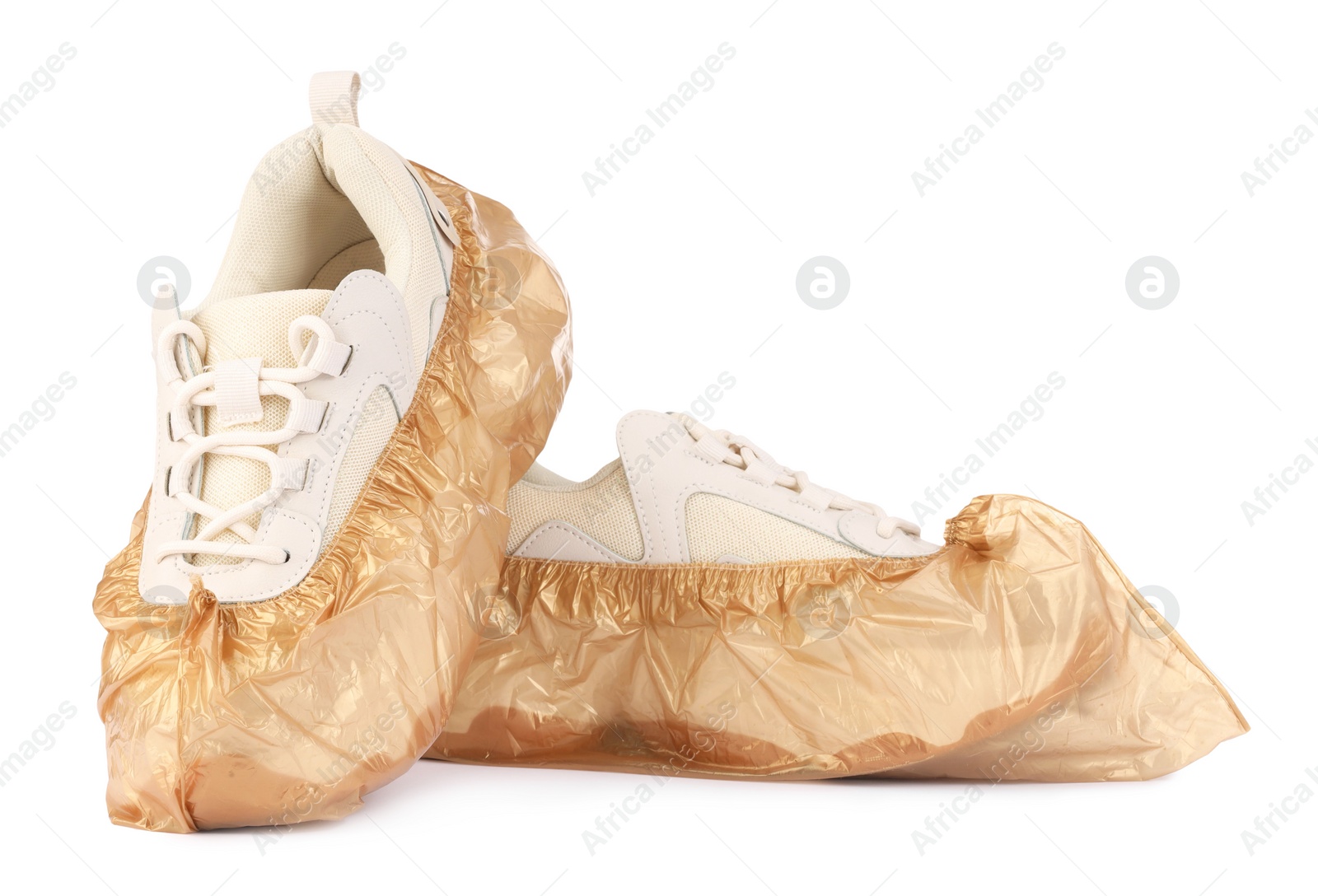 Photo of Sneakers in brown shoe covers isolated on white