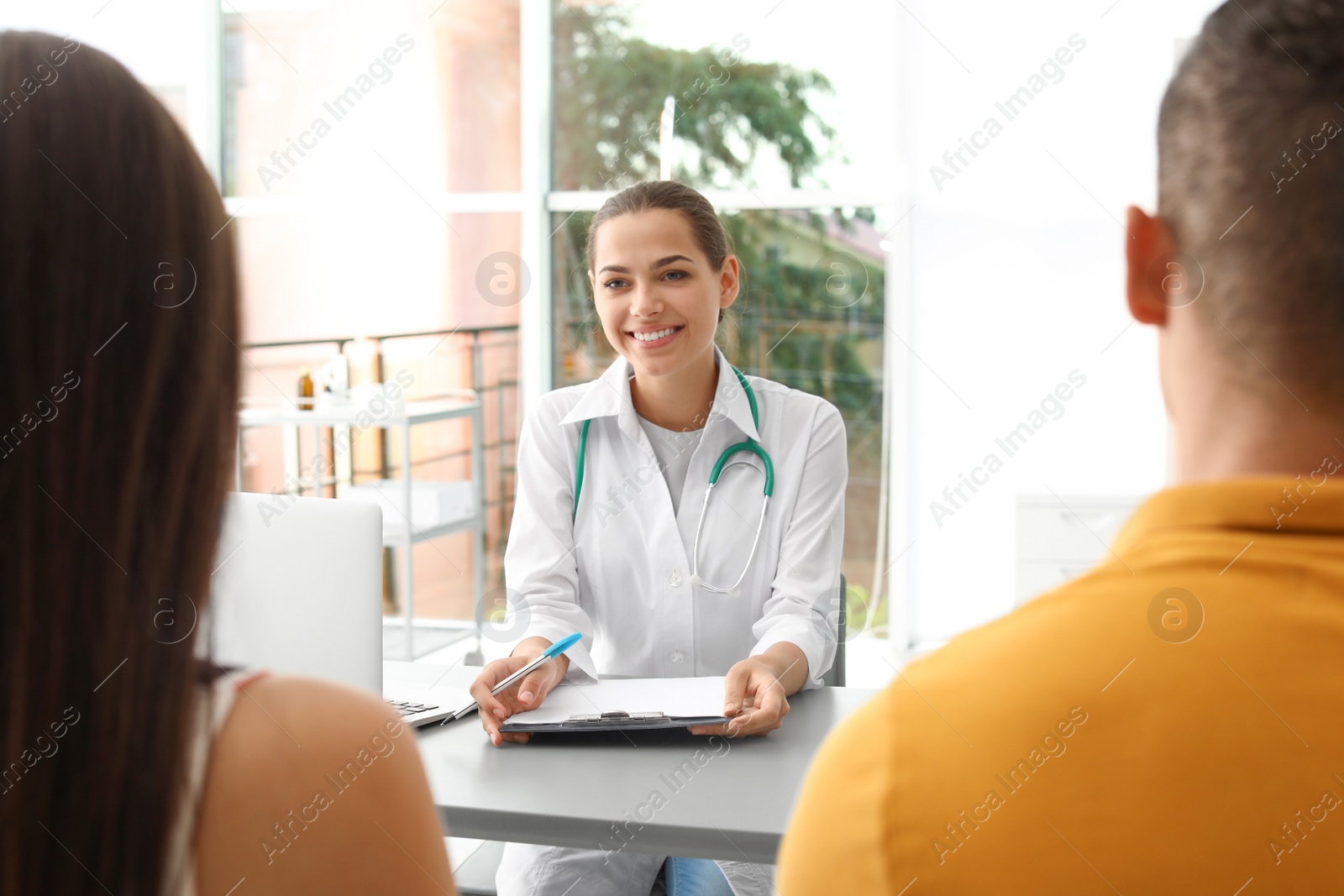 Photo of Doctor talking to her patients in hospital