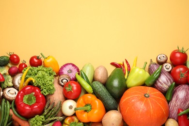 Photo of Flat lay composition with fresh vegetables on yellow background. Space for text