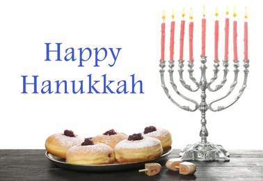 Image of Happy Hanukkah. Silver menorah, sufganiyot and dreidels on wooden table