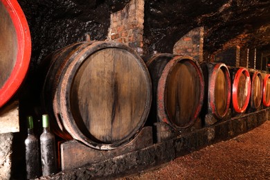 Many wooden barrels with alcohol drinks in cellar