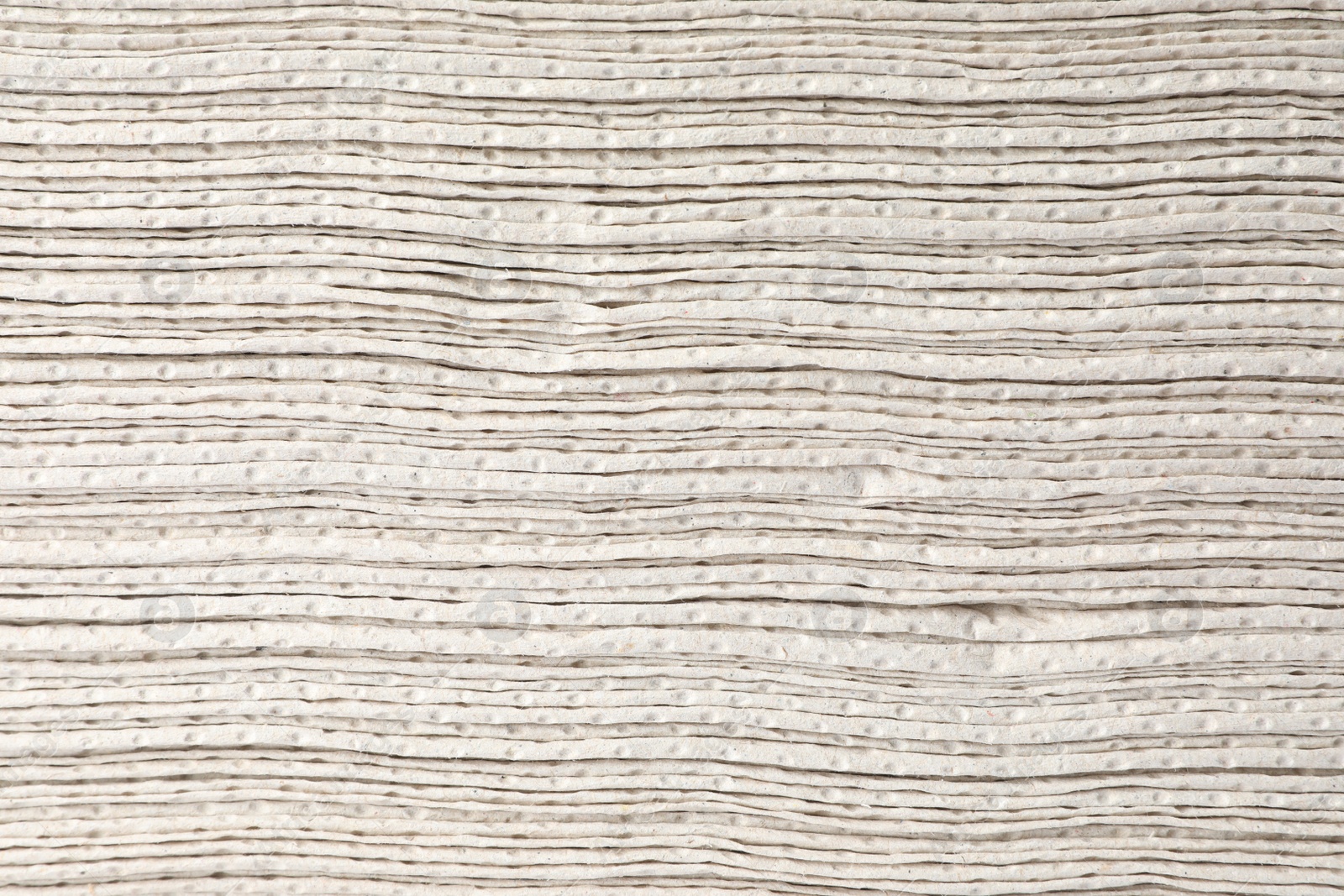 Photo of Texture staked of paper towels as background, closeup view