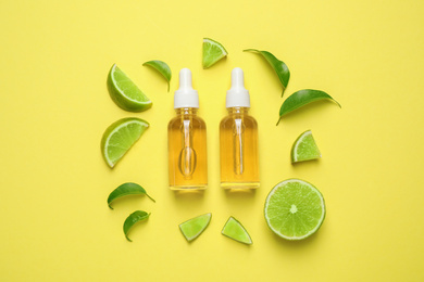 Photo of Flat lay composition with lime essential oil on yellow background