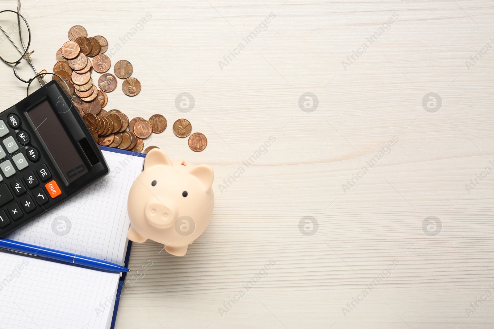 Photo of Calculator, piggy bank, notebook, pen and coins on white wooden table, flat lay. Space for text