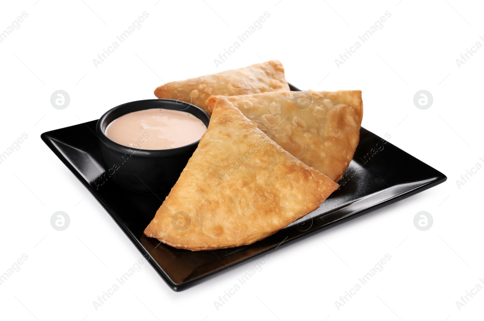 Photo of Fresh delicious crispy samosas with sauce on white background