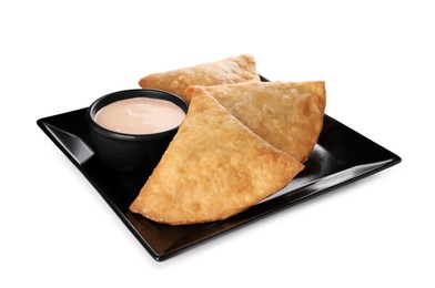 Photo of Fresh delicious crispy samosas with sauce on white background