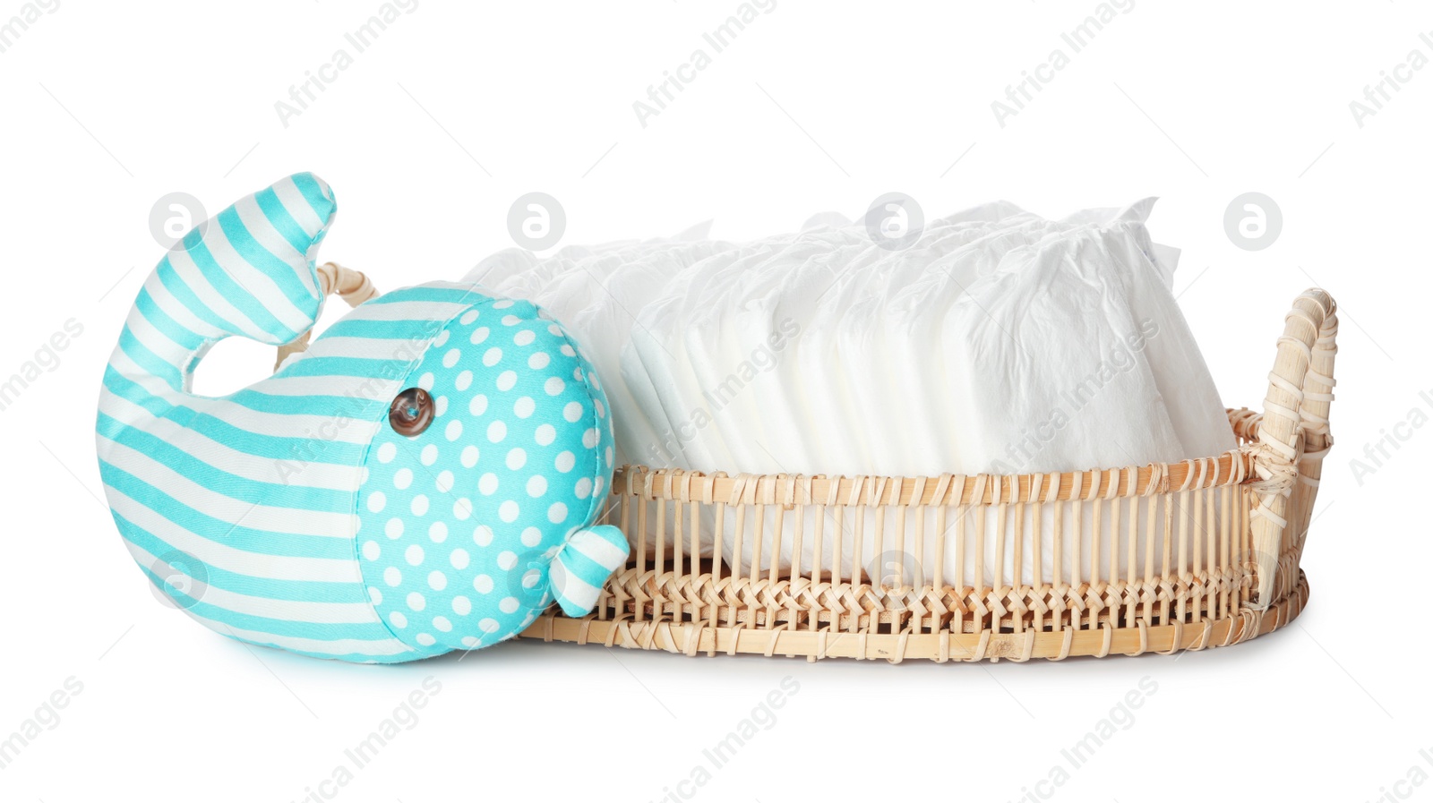 Photo of Wicker tray with disposable diapers and toy on white background