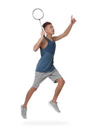 Young man playing badminton with racket on white background