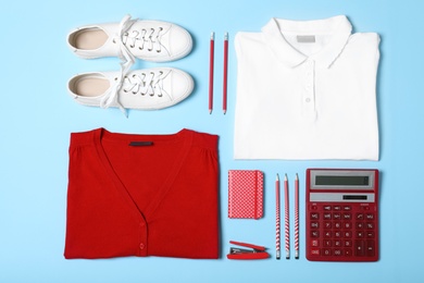 Photo of Flat lay composition with school uniform on blue background