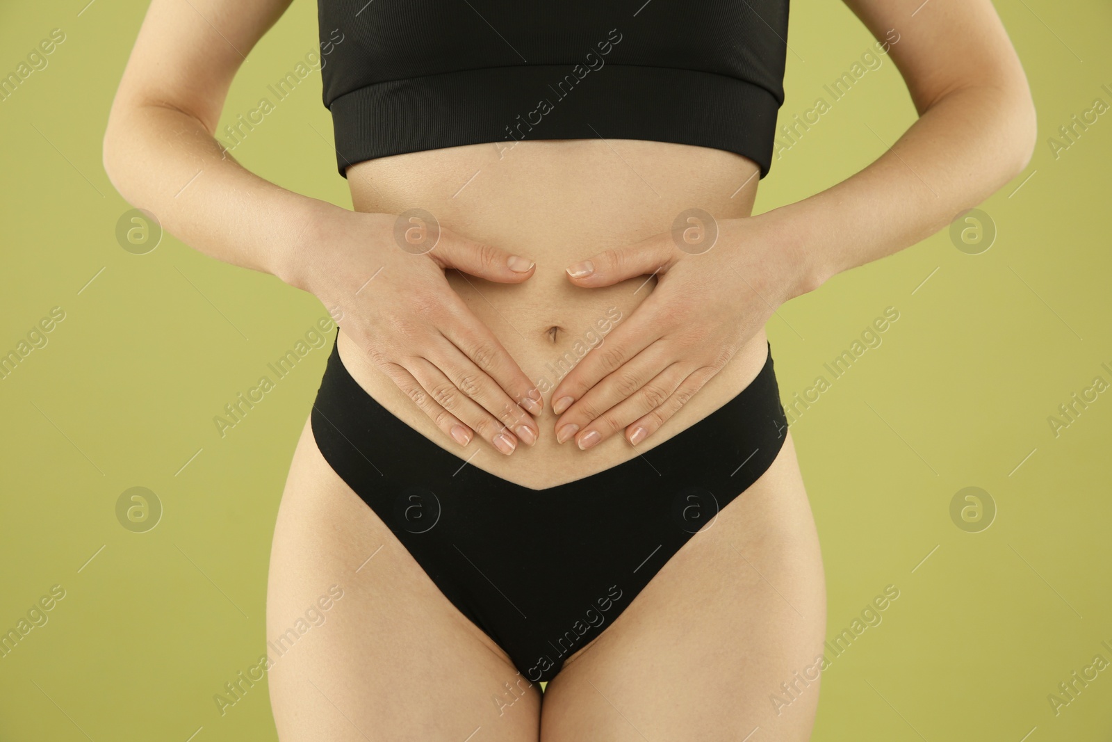 Photo of Gynecology. Woman in underwear on green background, closeup