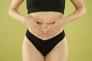 Photo of Gynecology. Woman in underwear on green background, closeup