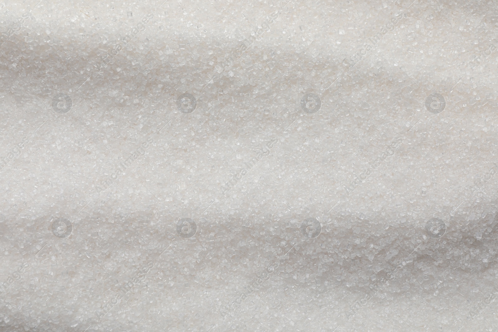 Photo of Sweet granulated sugar as background, top view