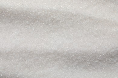 Photo of Sweet granulated sugar as background, top view