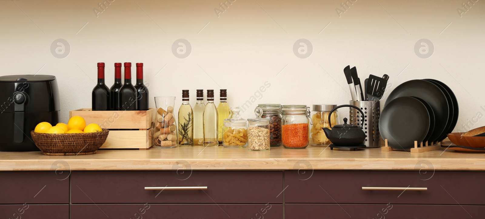 Photo of Stylish kitchen interior with wooden countertop and wall cabinets