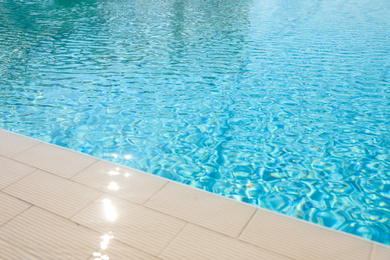 Outdoor swimming pool with clear water on sunny day. Summer vacation