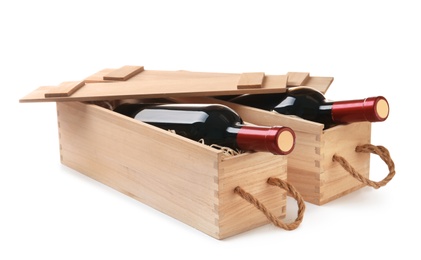 Wooden crates with expensive wine isolated on white