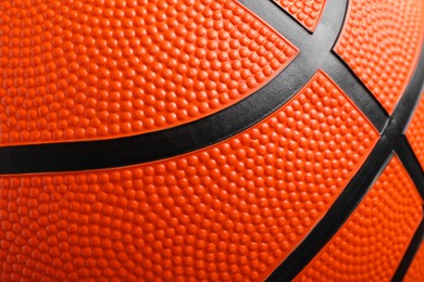 Photo of Orange basketball ball as background, closeup view