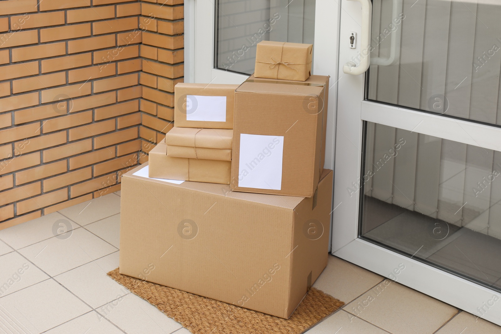 Photo of Delivered parcels on door mat near entrance