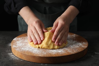 Making shortcrust pastry. Woman kneading dough at table, closeup