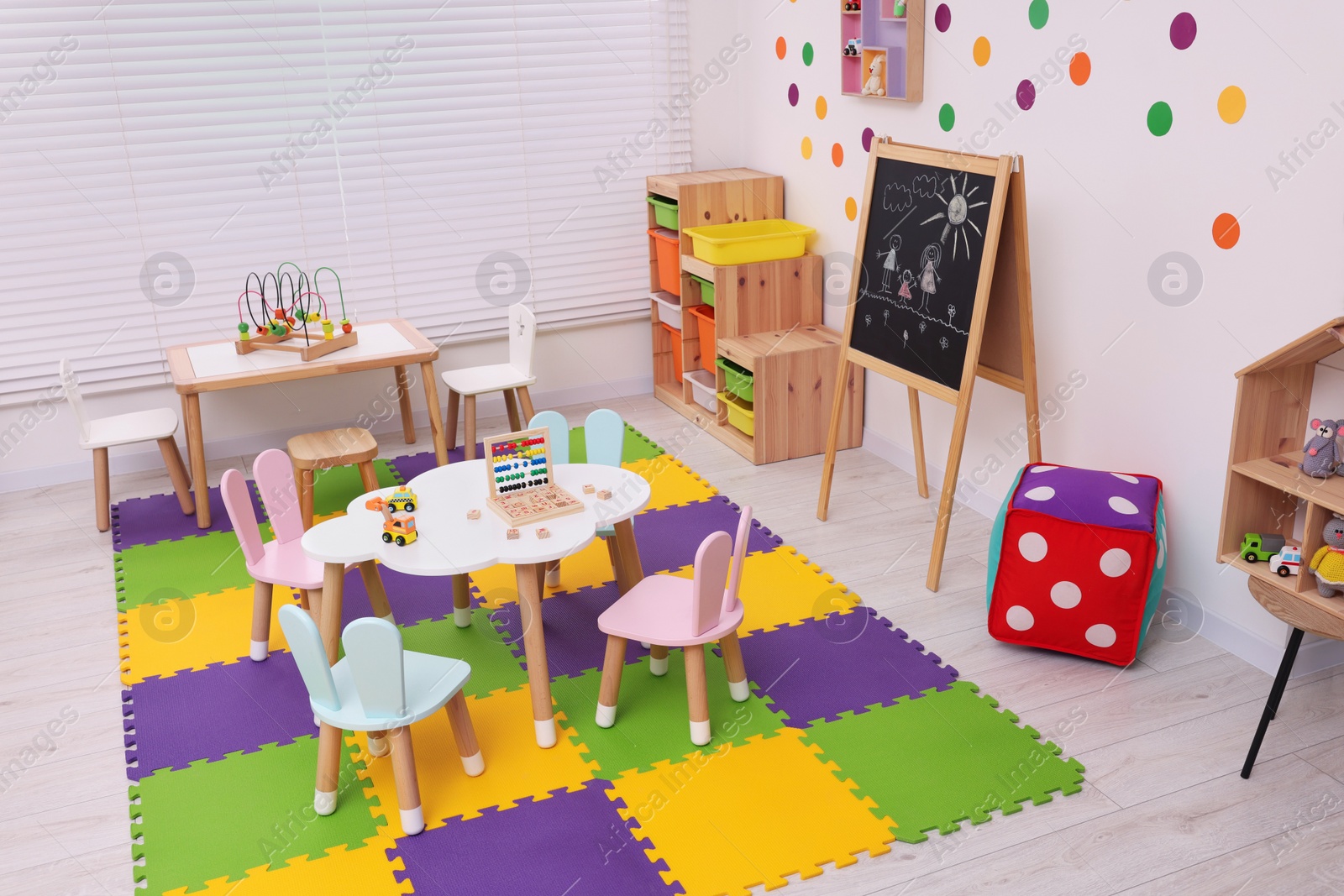 Photo of Stylish kindergarten interior with toys and modern furniture