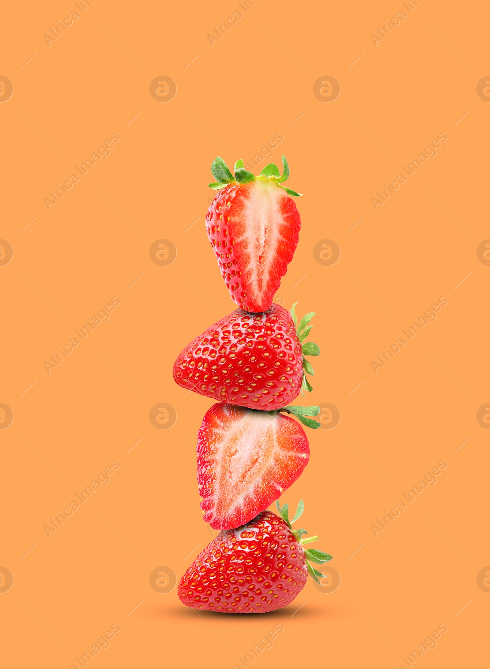 Image of Stack of fresh strawberries on orange background