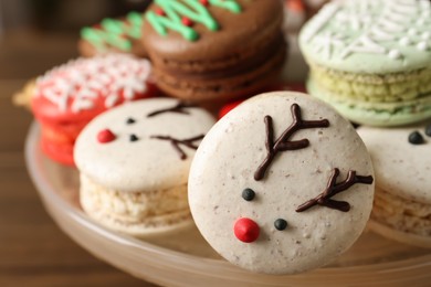 Beautifully decorated Christmas macarons on dish, closeup