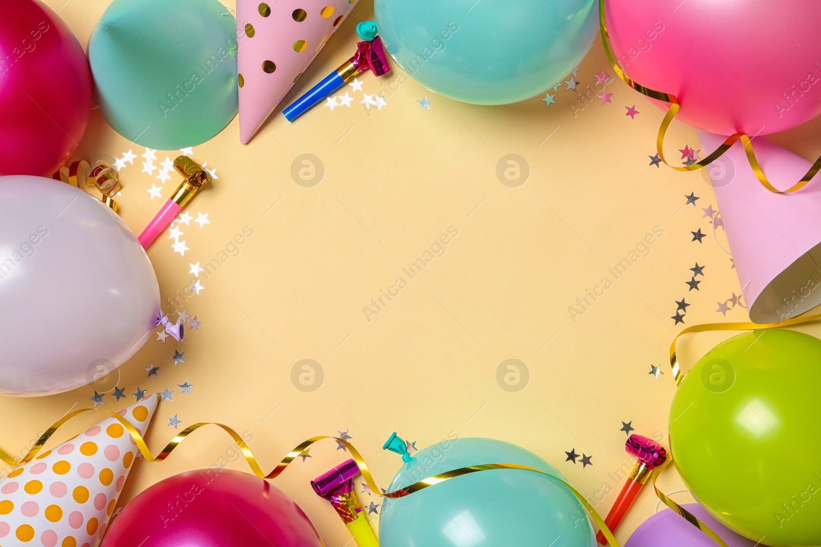 Photo of Frame made of balloons and party accessories on color background, top view with space for text