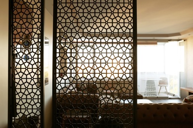 Photo of Interior of living room, view through decorative room divider