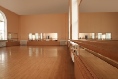 Photo of View of empty studio, focus on ballet barre. Space for text