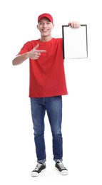 Happy courier pointing at clipboard on white background