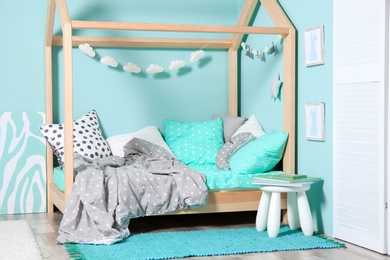 Photo of Comfortable bed in modern children room