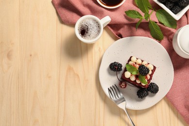 Photo of Piece of delicious red velvet cake with fresh berries served on wooden table, flat lay. Space for text