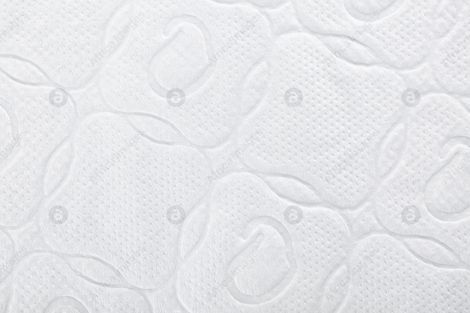 Photo of Perforated toilet paper as background, closeup. Personal hygiene