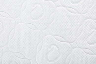 Photo of Perforated toilet paper as background, closeup. Personal hygiene