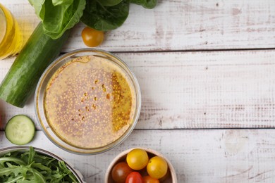 Tasty vinegar based sauce (Vinaigrette) in bowl and products on wooden rustic table, flat lay. Space for text