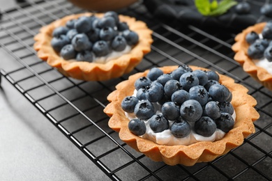 Photo of Delicious sweet pastry with berries on grey table