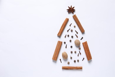 Photo of Christmas tree made of different spices on white table, flat lay. Space for text